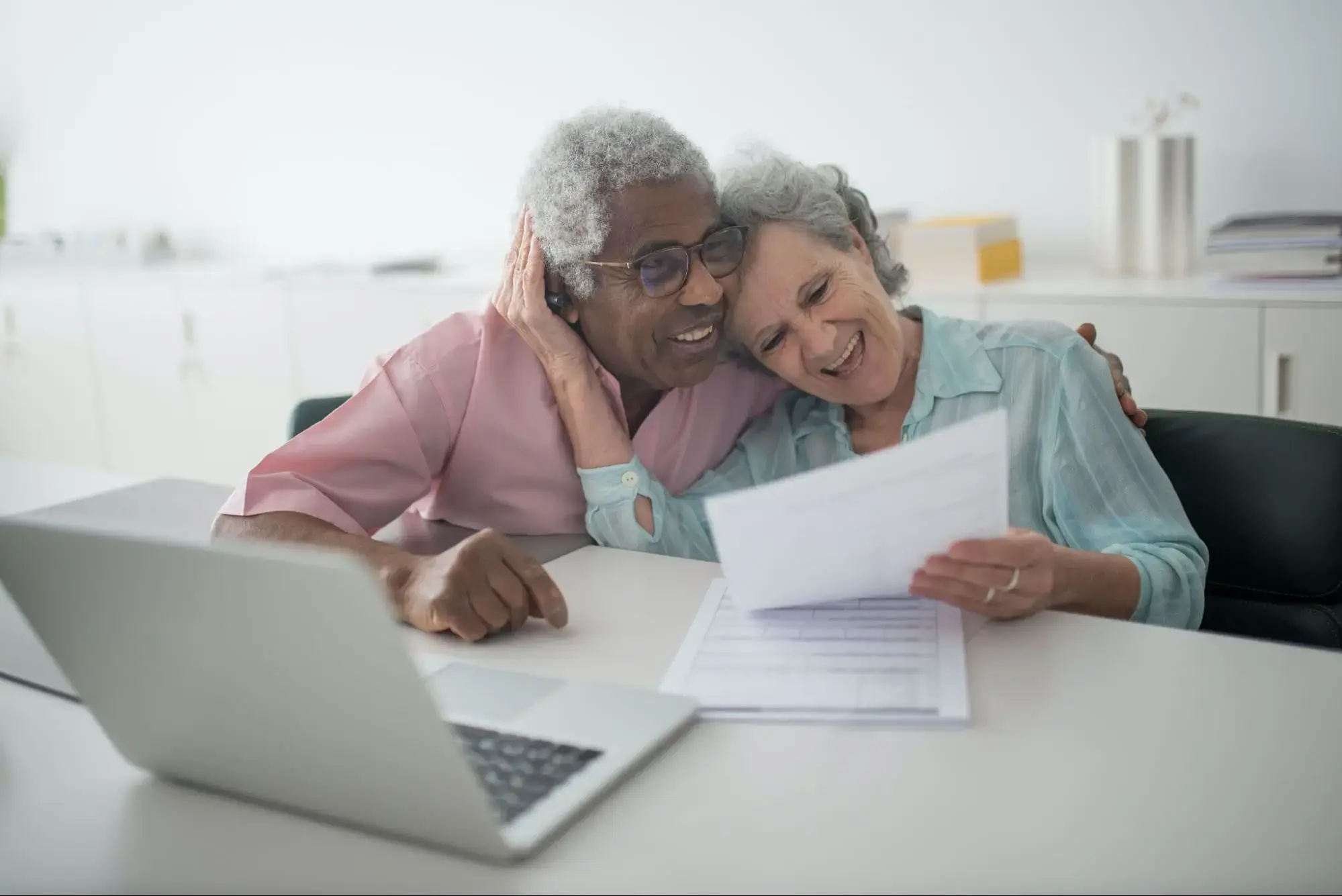 An elderly couple that are happy because they were able to renew their Life Insurance Plan.
