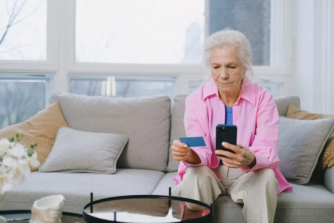 An elderly woman with her Flex card.