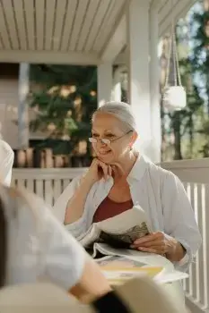An elderly woman reading about the different enrollment periods.