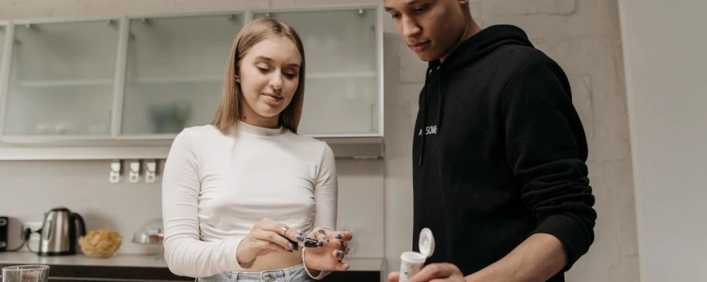 A young couple with diabetes, who are checking their blood sugar levels.