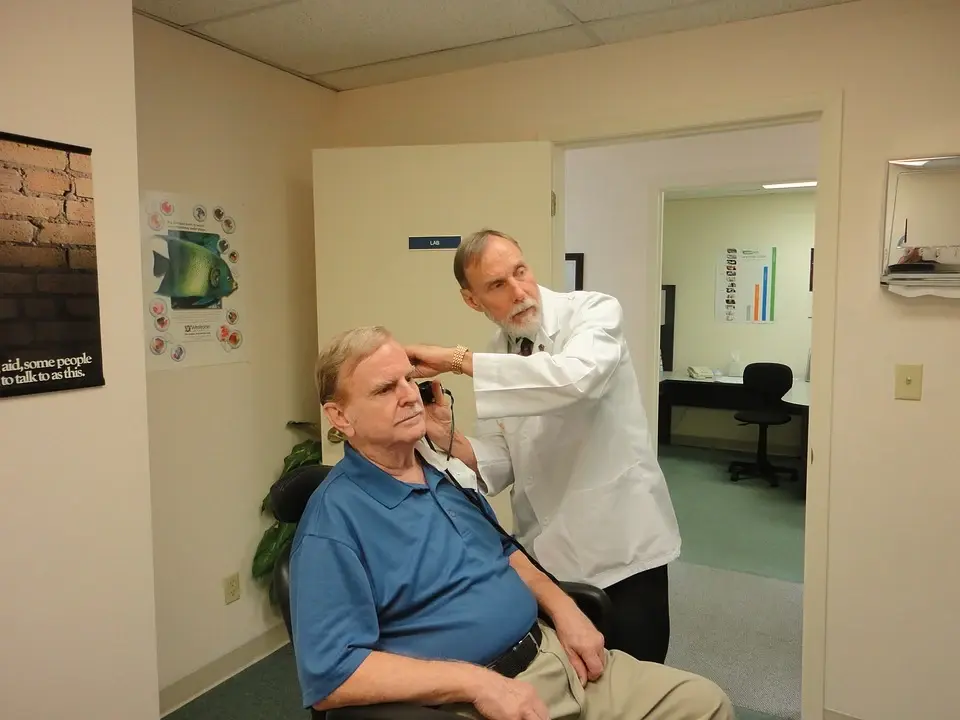 An elderly man getting his hearing tested.