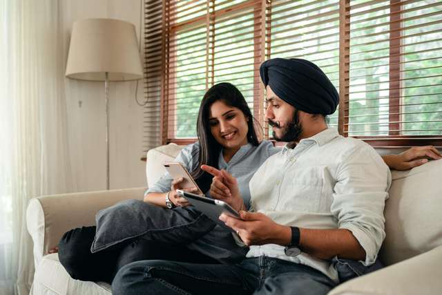Source: https://www.pexels.com/photo/young-indian-couple-surfing-mobile-phone-and-tablet-on-sofa-4307928/