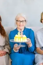 Woman celebrating her birthday and is now eligible for certain Medicare options.