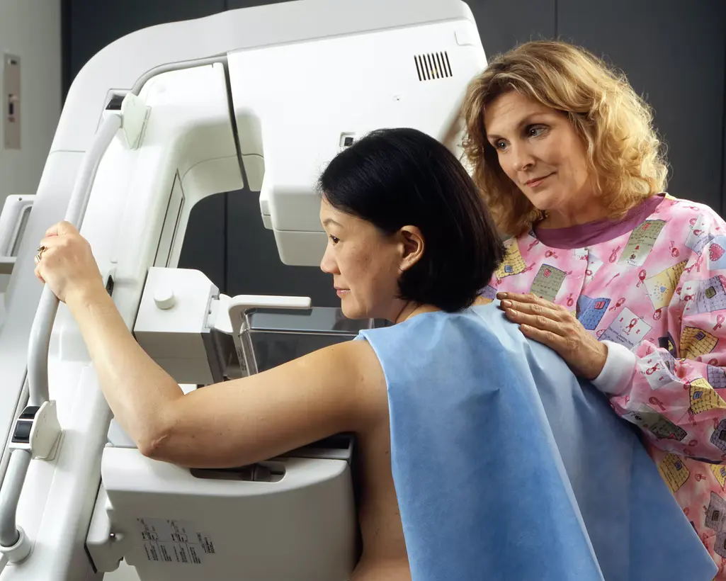 A lady receiving a mammogram to see if she needs a Mastectomy.