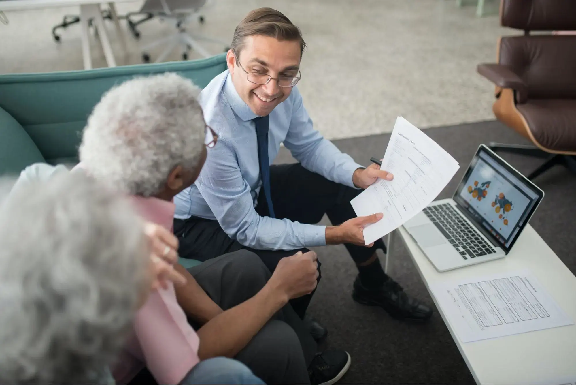 An insurance agent explaining to an elderly couple how Renewable Term Insurance works.