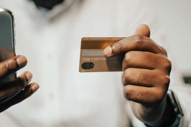 https://www.pexels.com/photo/person-holding-brown-credit-card-and-cellphone-5198284/