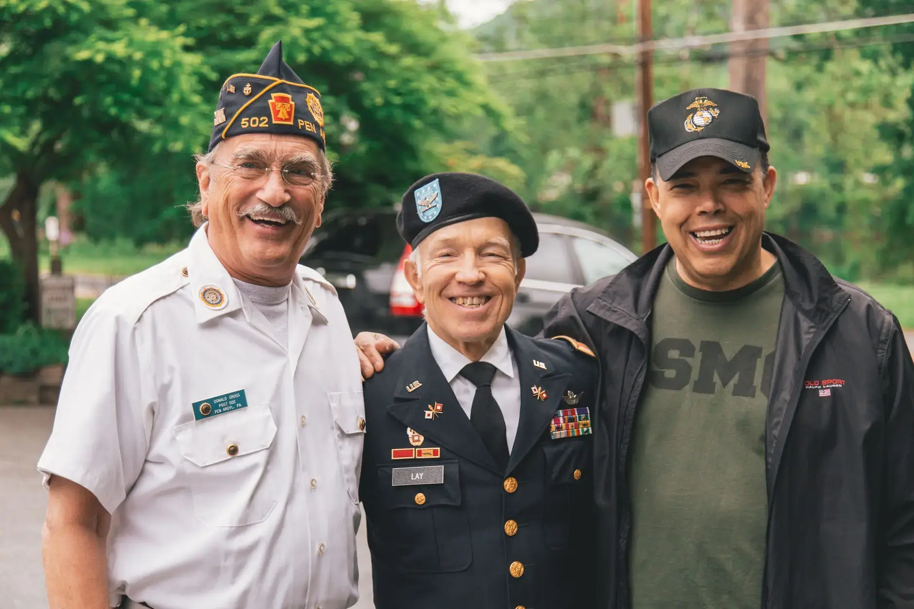 A group of veterans smiling because TRICARE and Medicare work together.