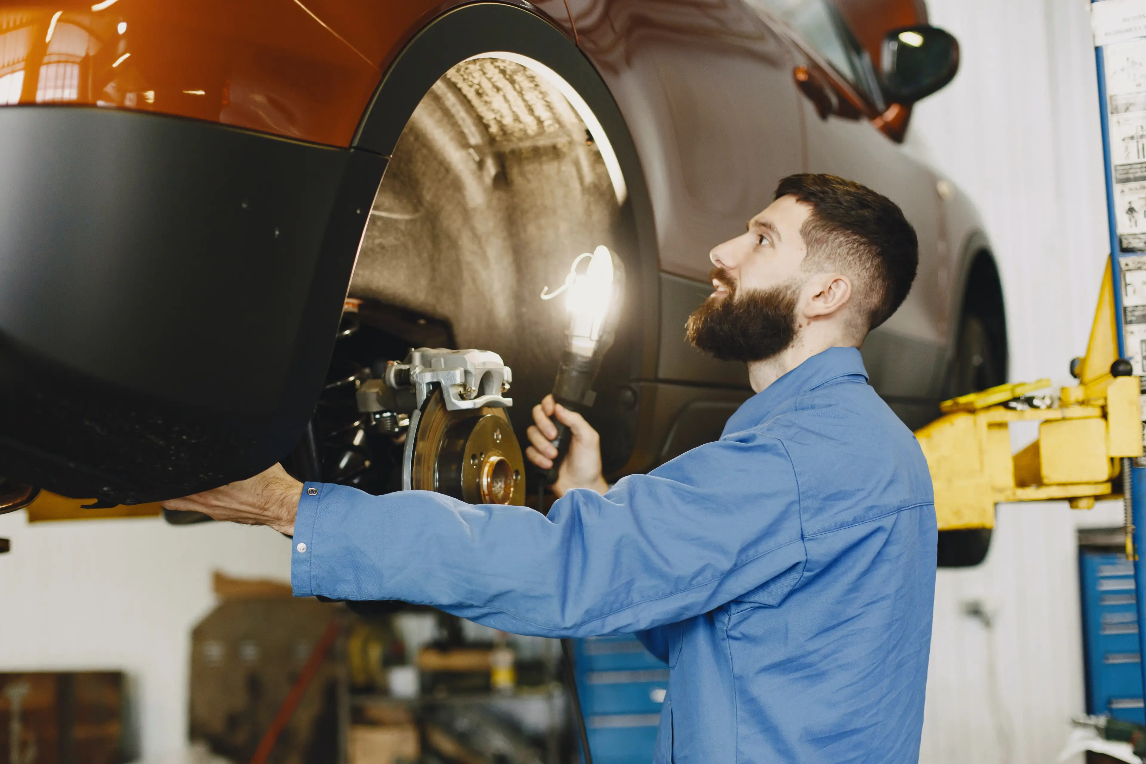 A Mechanic performing vehicle repairs that are covered under the car warranty coverage service contract