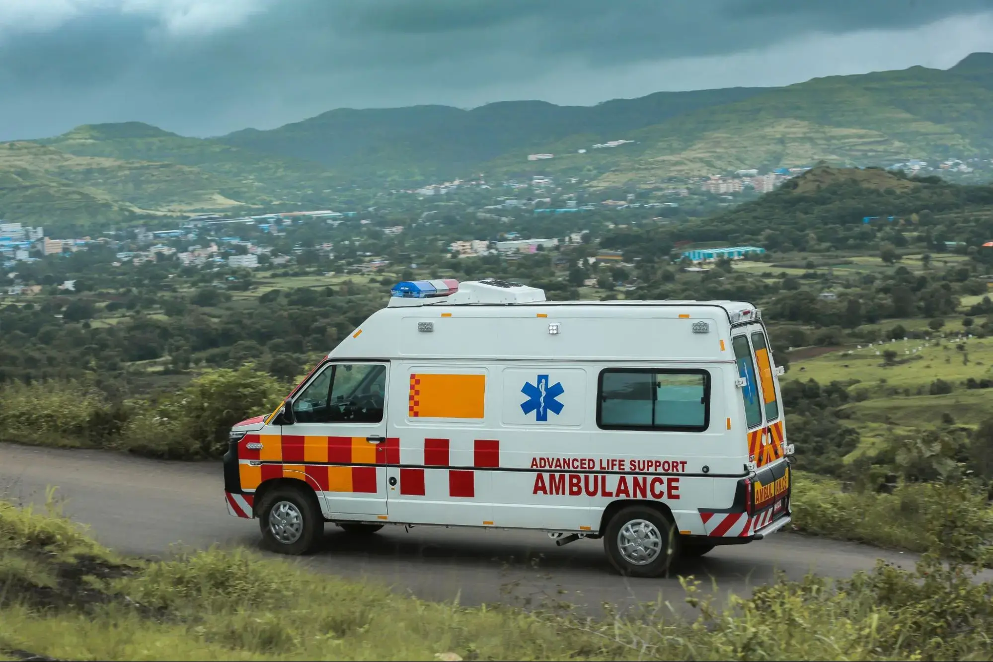 White Ambulance on the Road taking a patient to a medical emergency facility